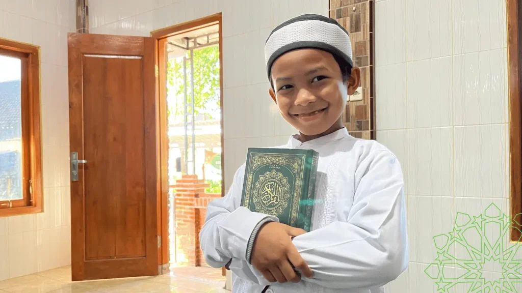 Happy kid holding the Holy Quran, representing personalized online Quran classes and Islamic studies for children.